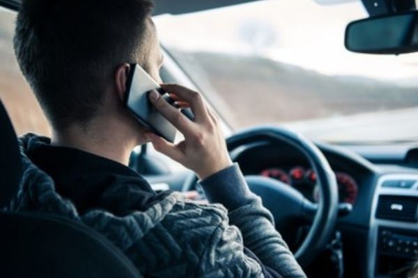 is it legal to talk on the phone while driving in oklahoma